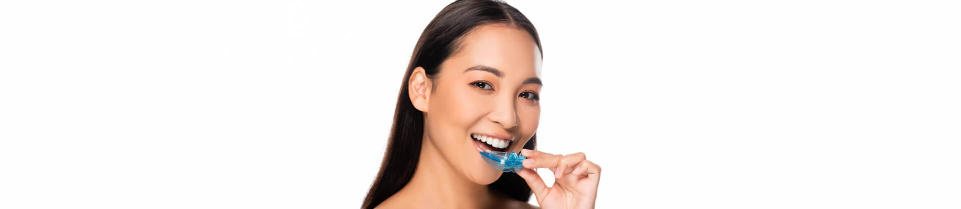 Woman inserting a mouth guard to her mouth