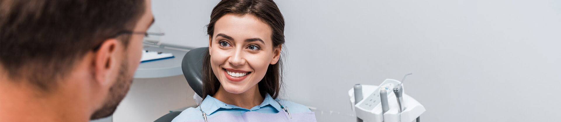 Selective focus of attractive woman looking at dentist